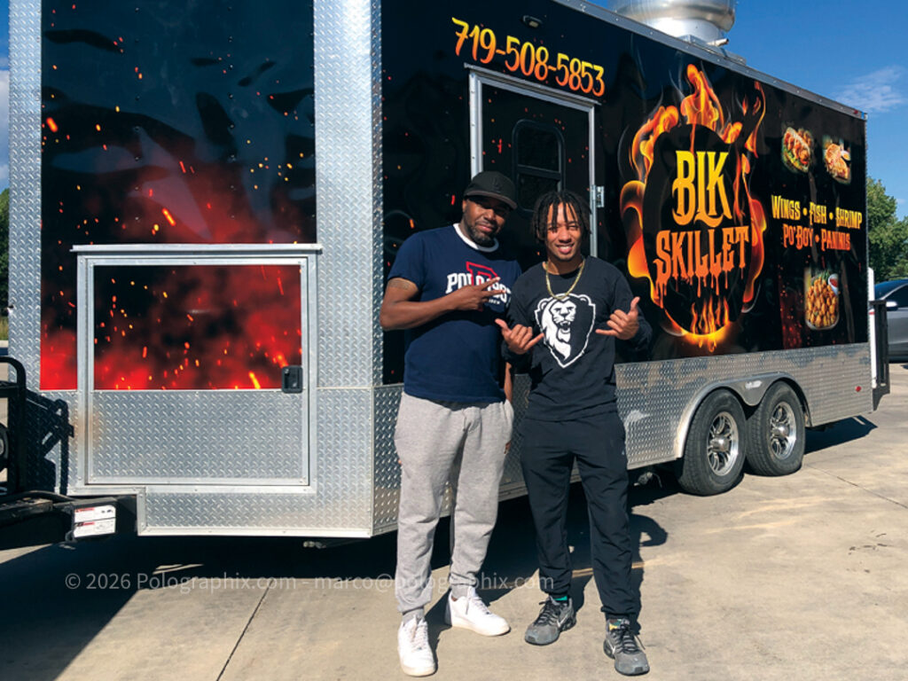 Proud owners of BK Skillet in front of their freshly wrapped trailer